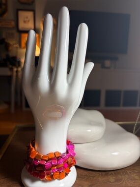 Vintage stretch bracelet stack featuring a mix of neon pink, red, and orange